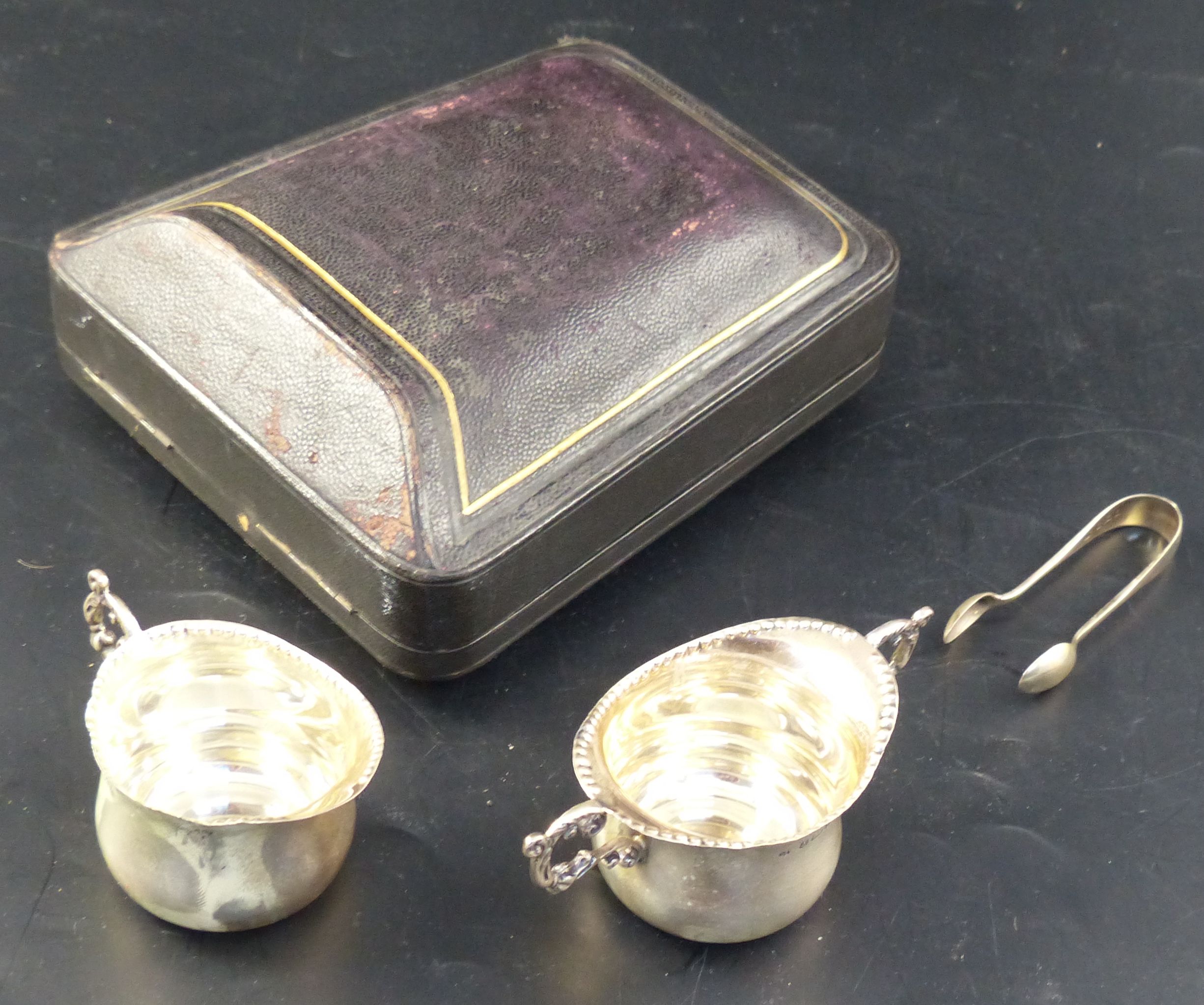 A late Victorian cased silver three piece cream and sugar set, 84 grams.